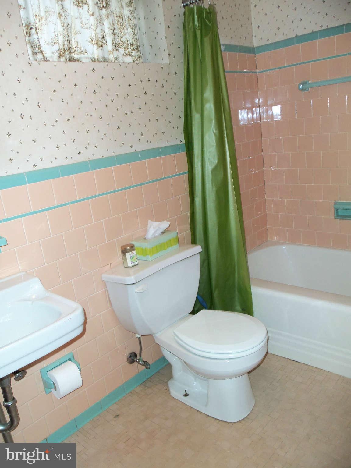 204 Hollen Road Baltimore, MD 21212 - Photo 22 of 30 a white toilet sitting next to a bath tub and a shower