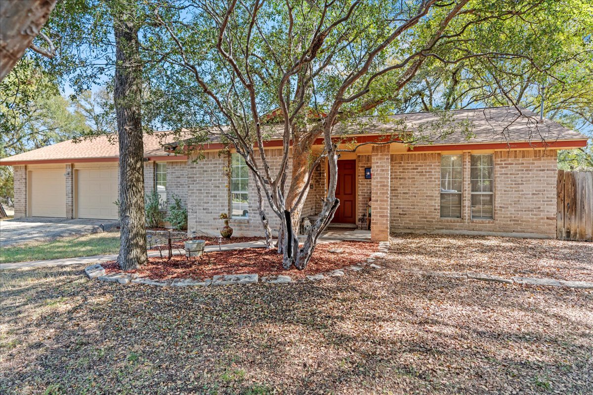 5403 Valencia Court Georgetown, TX 78628 - Photo 1 of 34 a view of a house with backyard and a tree