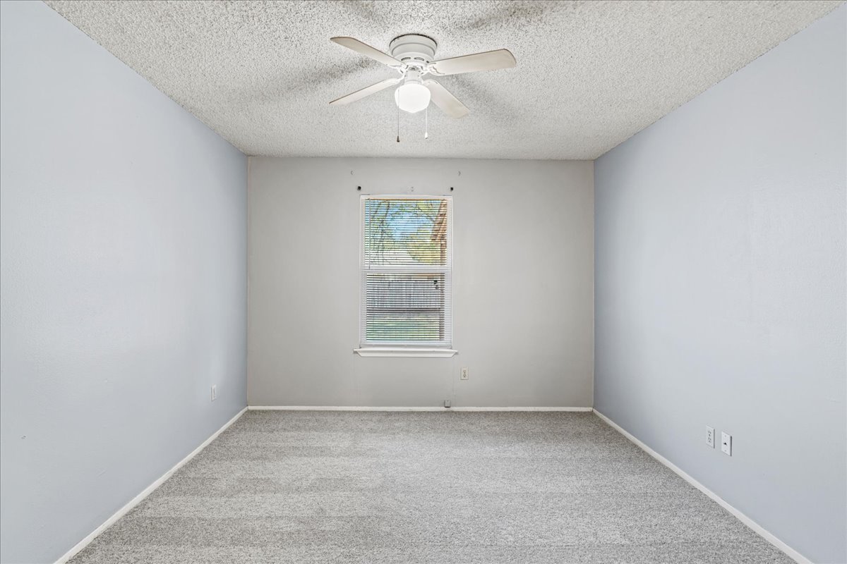 5403 Valencia Court Georgetown, TX 78628 - Photo 12 of 34 an empty room with a window and a fan
