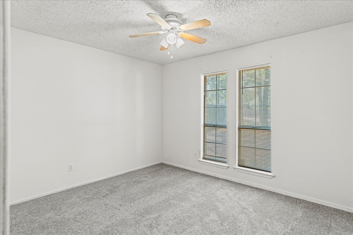 5403 Valencia Court Georgetown, TX 78628 - Photo 23 of 34 an empty room with windows and fan