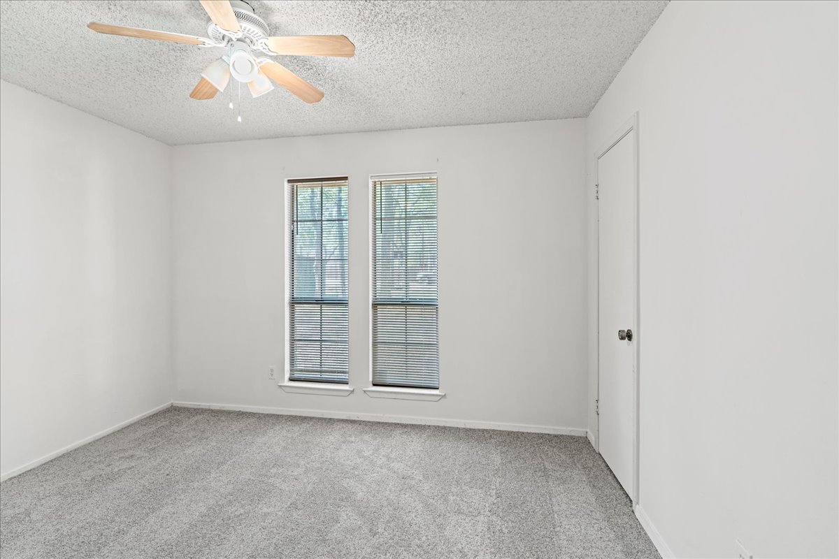 5403 Valencia Court Georgetown, TX 78628 - Photo 24 of 34 an empty room with windows and fan
