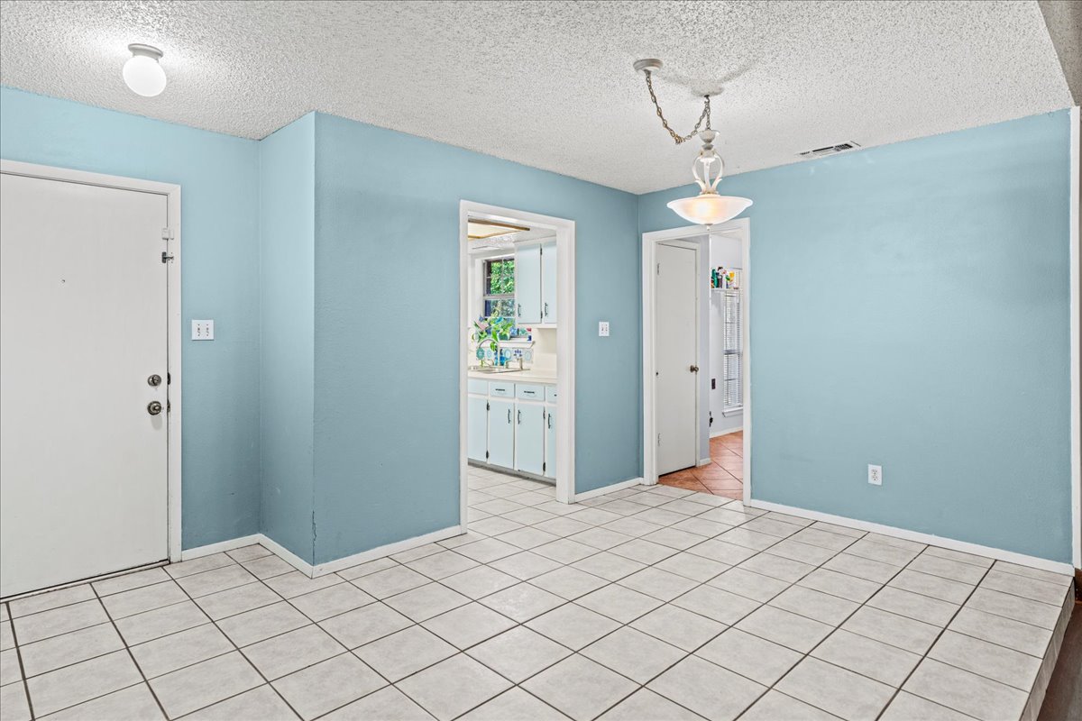 5403 Valencia Court Georgetown, TX 78628 - Photo 5 of 34 a bedroom with a bed and a chandelier