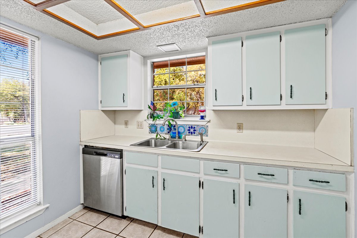 5403 Valencia Court Georgetown, TX 78628 - Photo 8 of 34 a kitchen with white cabinets and a window