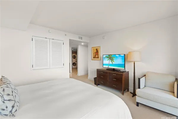 a bedroom with a bed and a couch