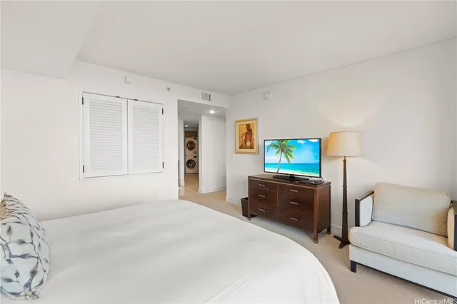 a bedroom with a bed and a couch