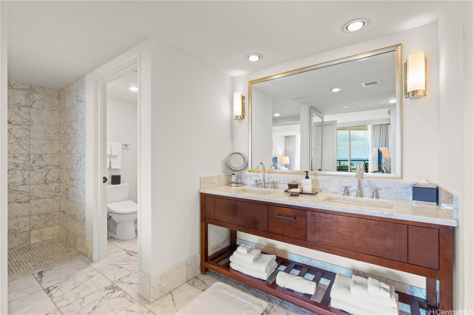 223 Saratoga Road, Unit 1115 Honolulu, HI 96815 - Photo 16 of 25 a bathroom with a sink a toilet and shower