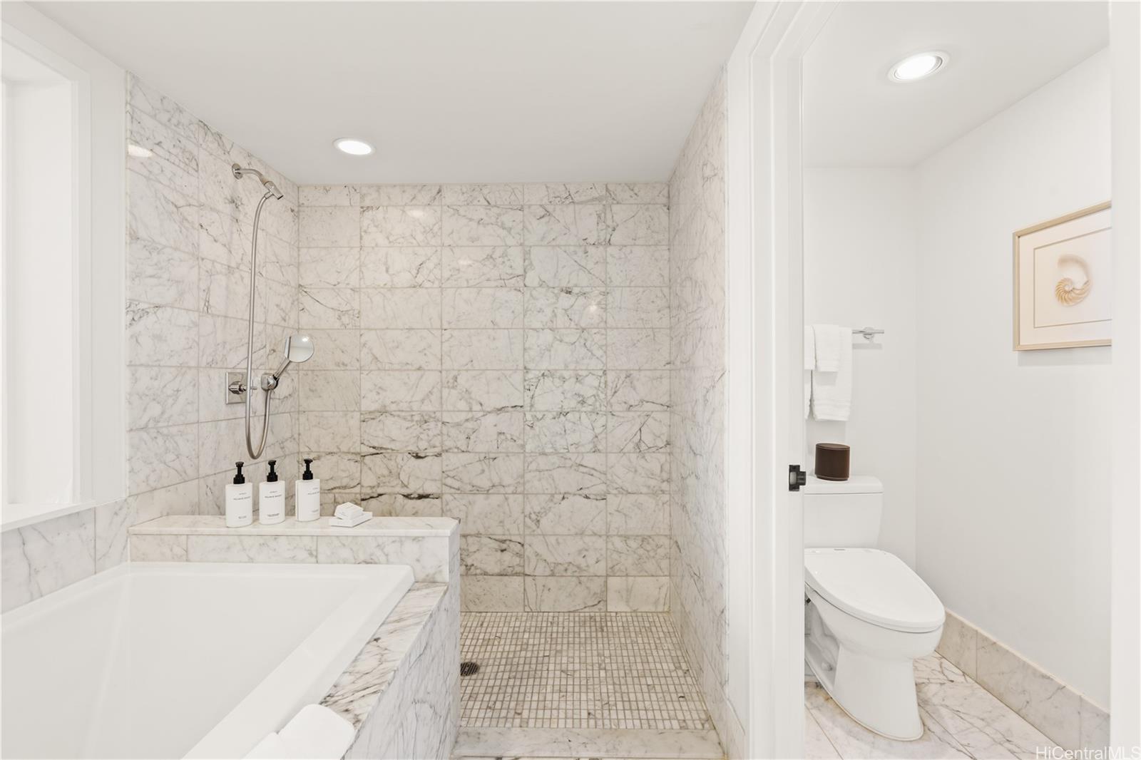 223 Saratoga Road, Unit 1115 Honolulu, HI 96815 - Photo 17 of 25 a bathroom with a sink a toilet and shower
