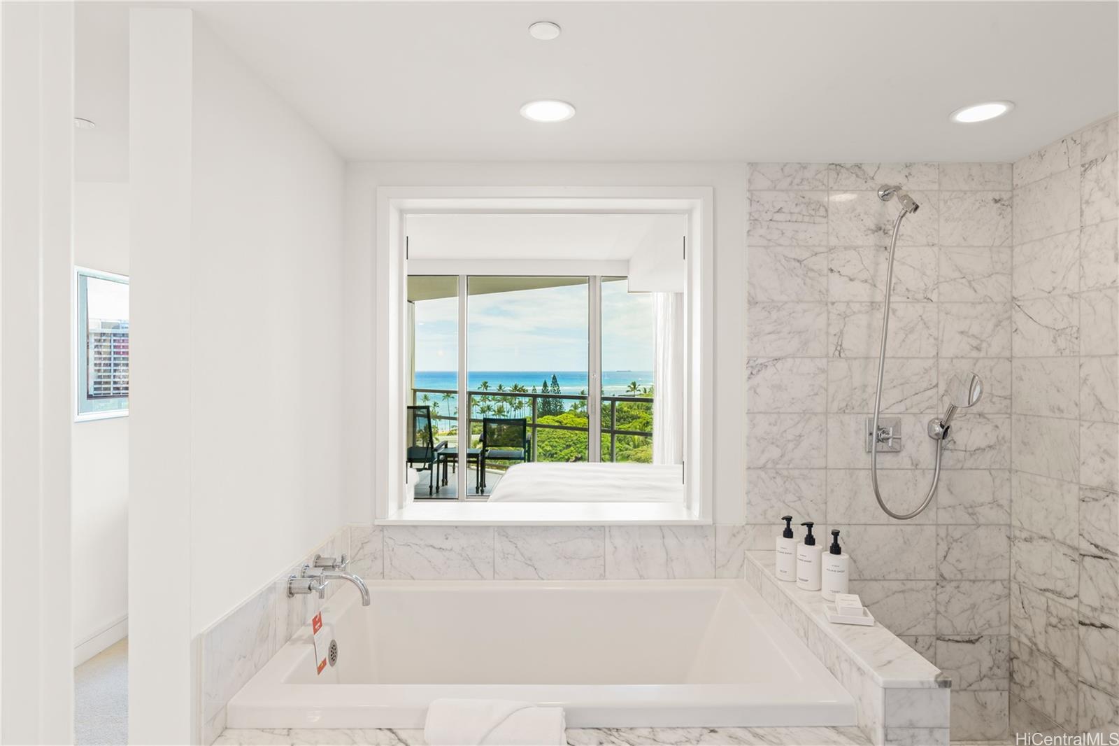 223 Saratoga Road, Unit 1115 Honolulu, HI 96815 - Photo 18 of 25 a white bath tub sitting next to a shower