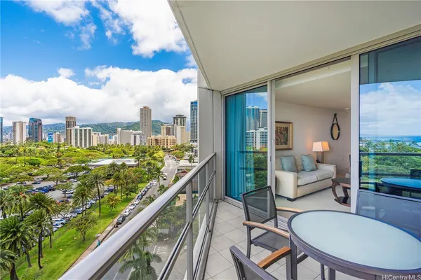 a balcony with table and chairs