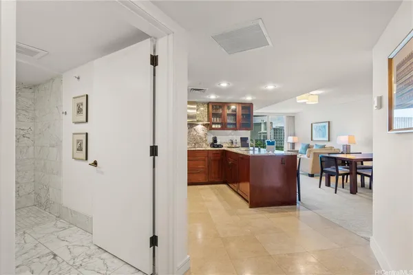 a living room with stainless steel appliances kitchen island granite countertop furniture and a view of kitchen