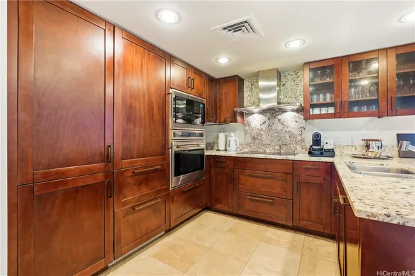 a kitchen with stainless steel appliances granite countertop cabinets and wooden floor