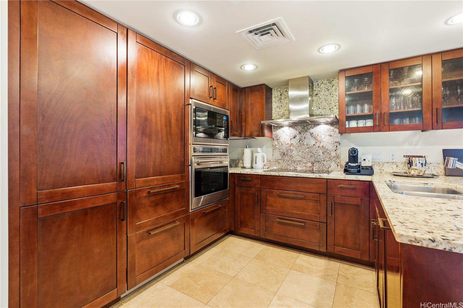 223 Saratoga Road, Unit 1115 Honolulu, HI 96815 - Photo 5 of 25 a kitchen with stainless steel appliances granite countertop cabinets and wooden floor
