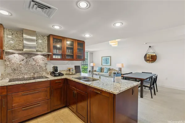 a kitchen with a sink a counter and chairs