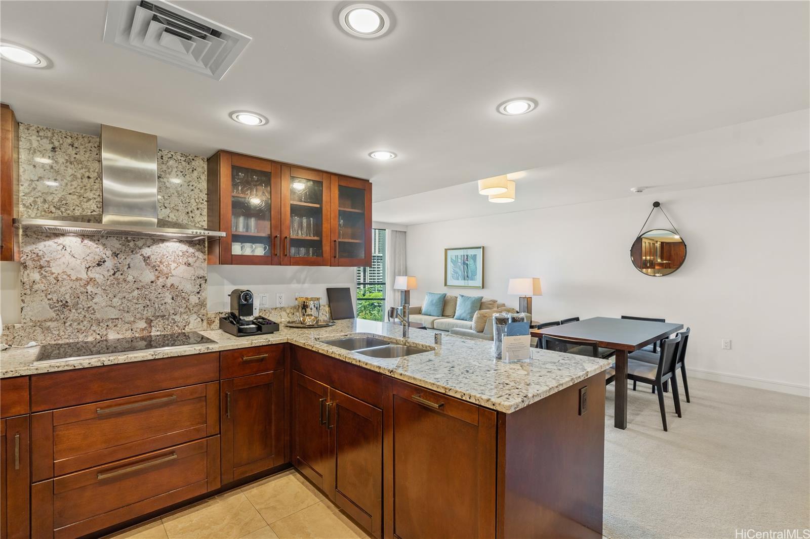 223 Saratoga Road, Unit 1115 Honolulu, HI 96815 - Photo 6 of 25 a kitchen with a sink a counter and chairs