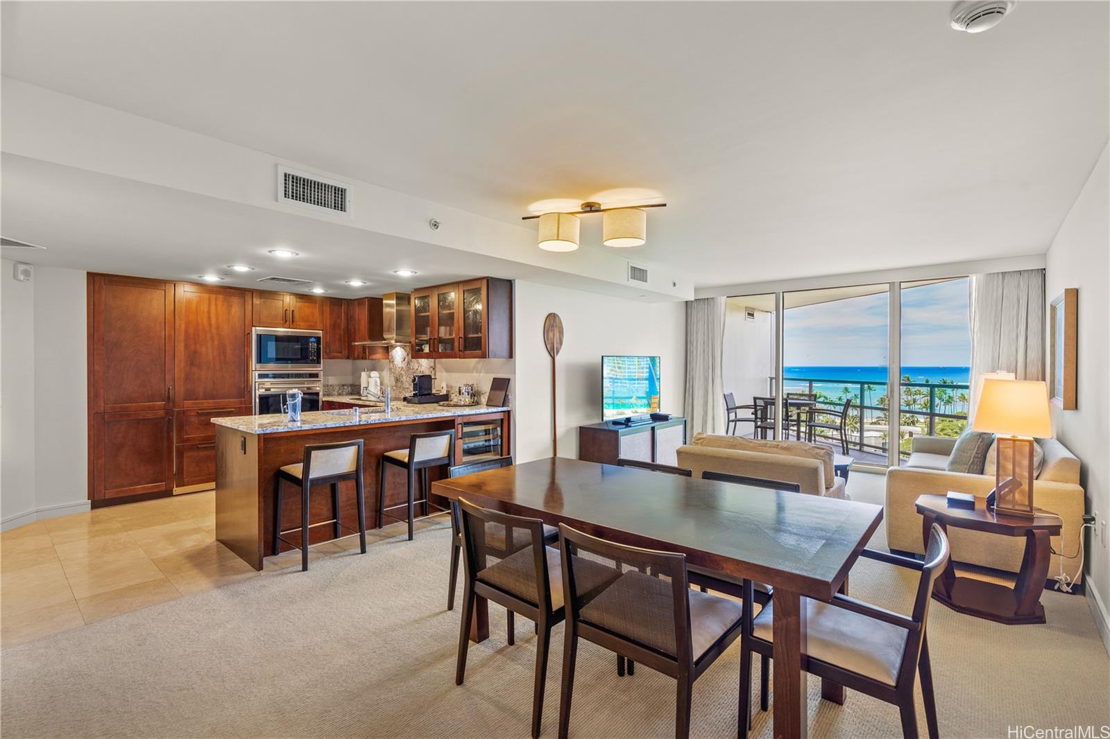 223 Saratoga Road, Unit 1115 Honolulu, HI 96815 - Photo 8 of 25 a dining area with furniture and a floor to ceiling window