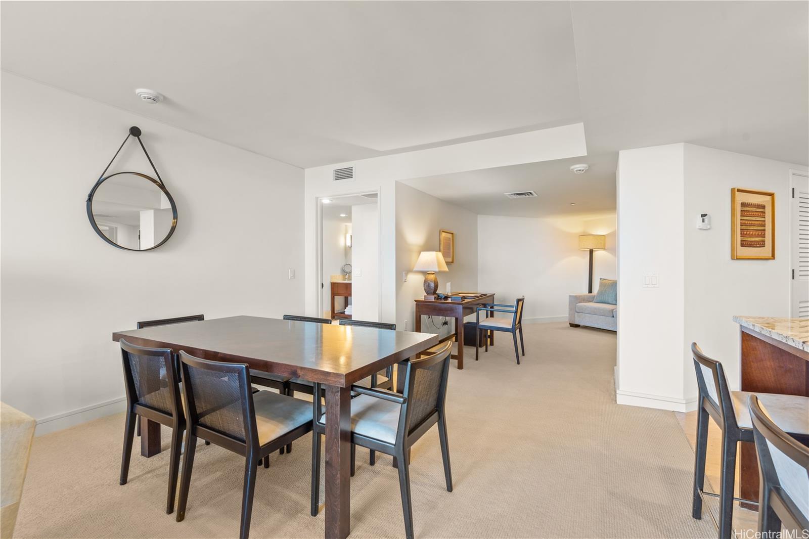223 Saratoga Road, Unit 1115 Honolulu, HI 96815 - Photo 10 of 25 a view of a dining room with furniture and a chandelier