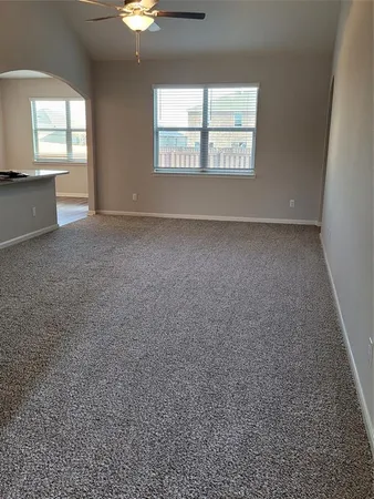 an empty room with a empty space and windows
