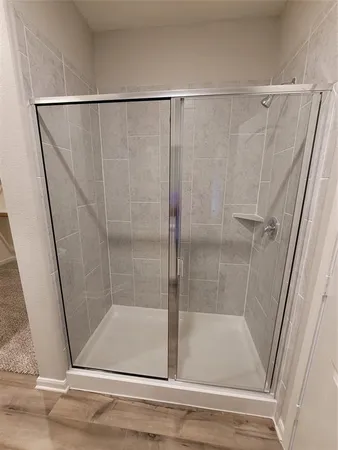 a bathroom with a glass shower door