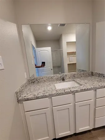 a bathroom with a sink and mirror