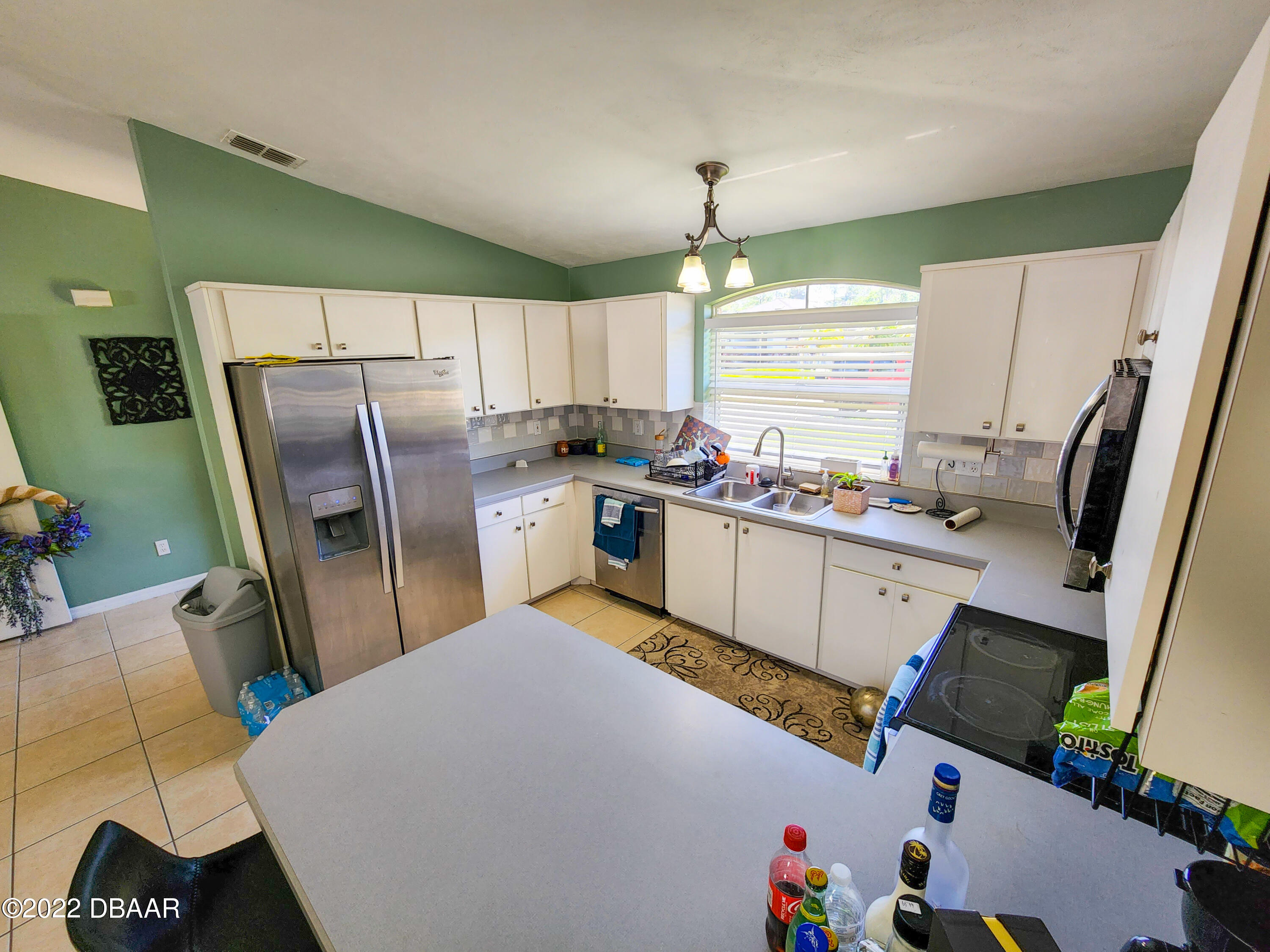 1467 Bay Grove Drive Port Orange, FL 32129 - Photo 14 of 35 a kitchen with refrigerator and window