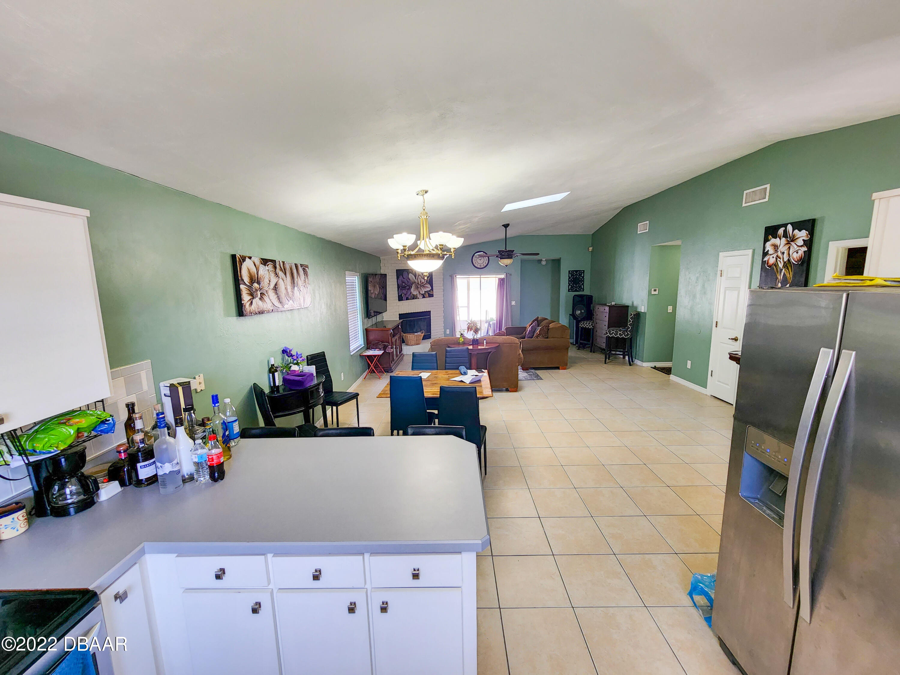 1467 Bay Grove Drive Port Orange, FL 32129 - Photo 16 of 35 a view of a dining room with furniture and a chandelier