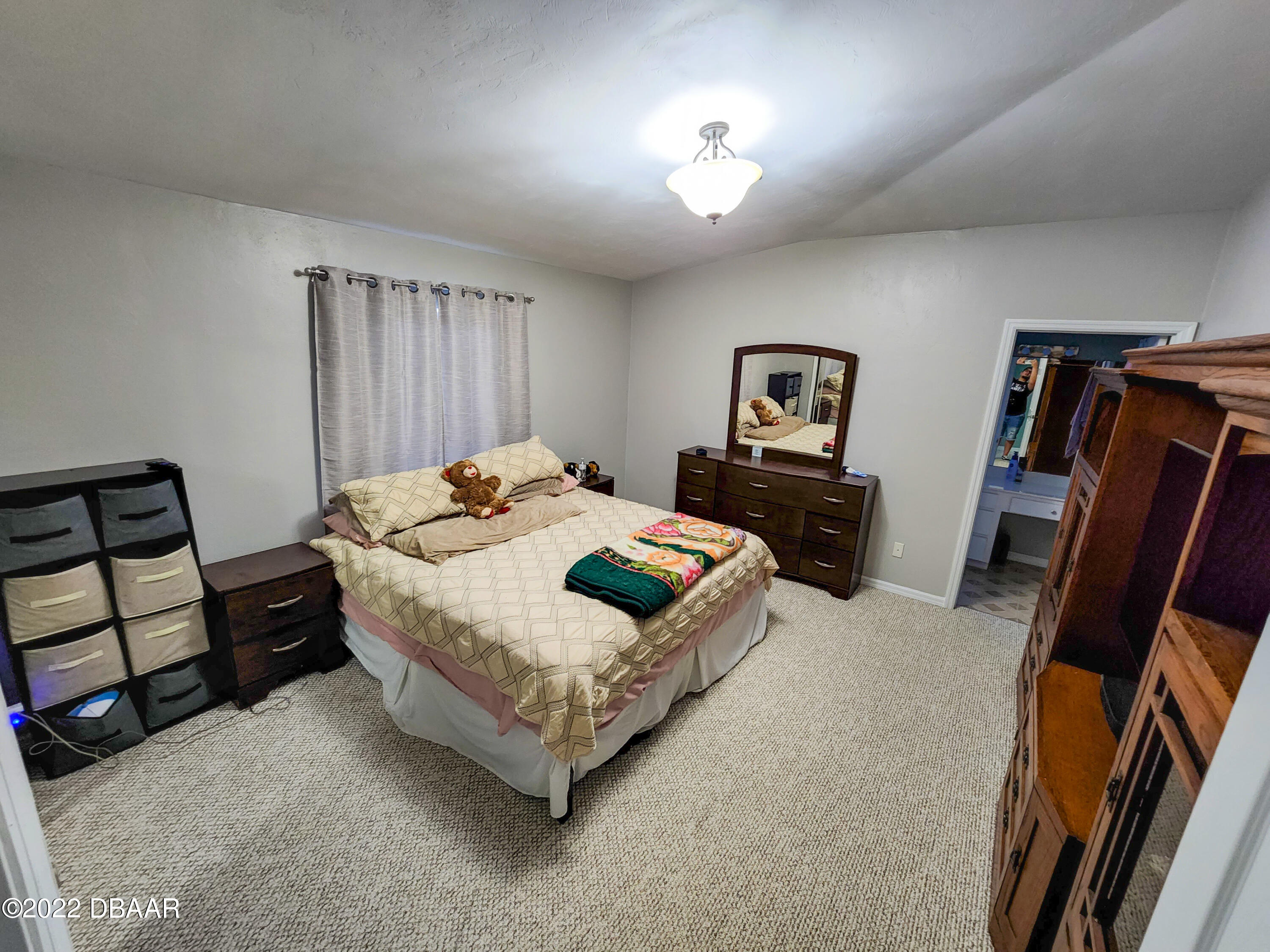 1467 Bay Grove Drive Port Orange, FL 32129 - Photo 23 of 35 a bedroom with furniture and a flat tv screen