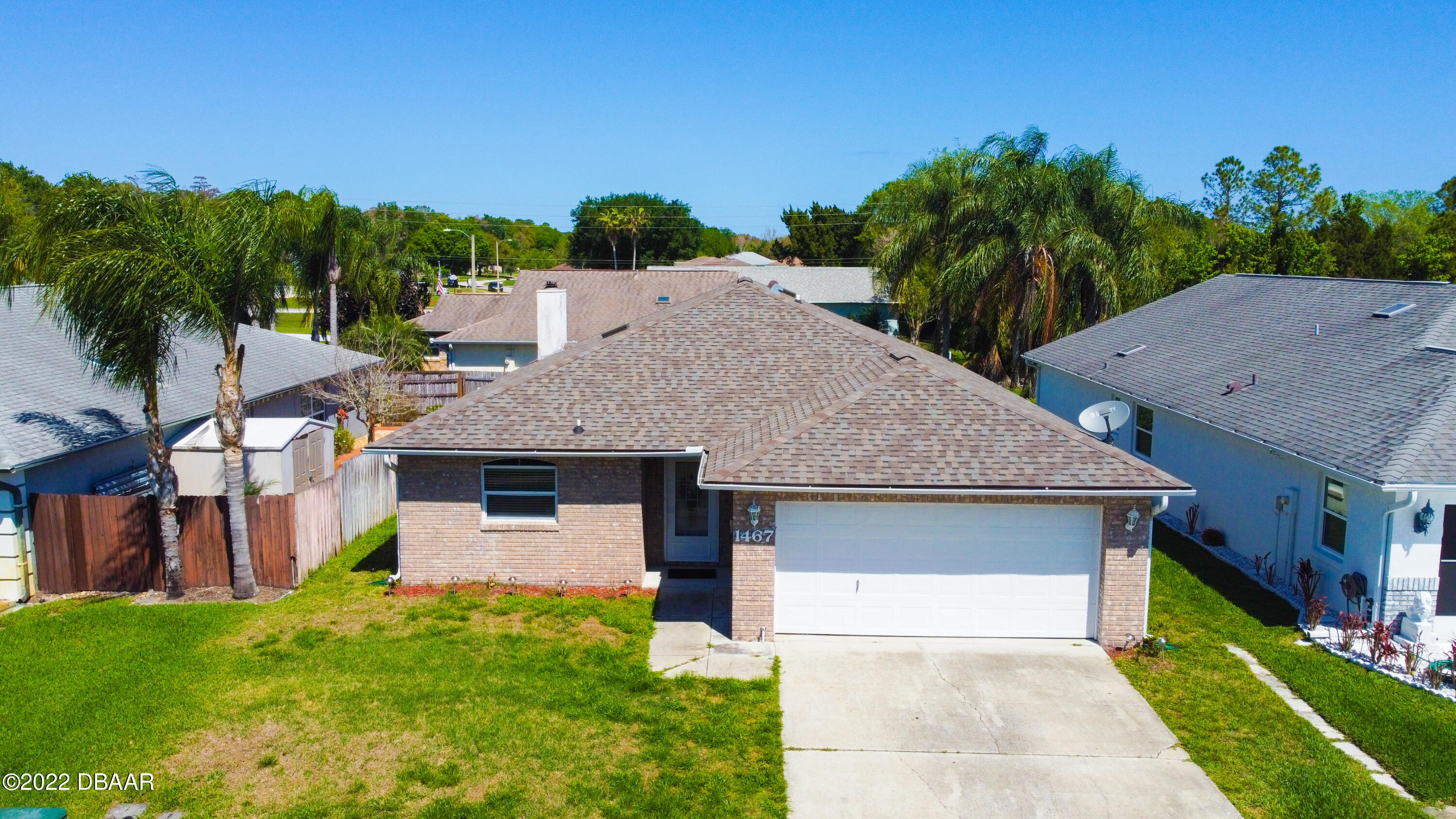 1467 Bay Grove Drive Port Orange, FL 32129 - Photo 30 of 35 a front view of a house with a yard and trees