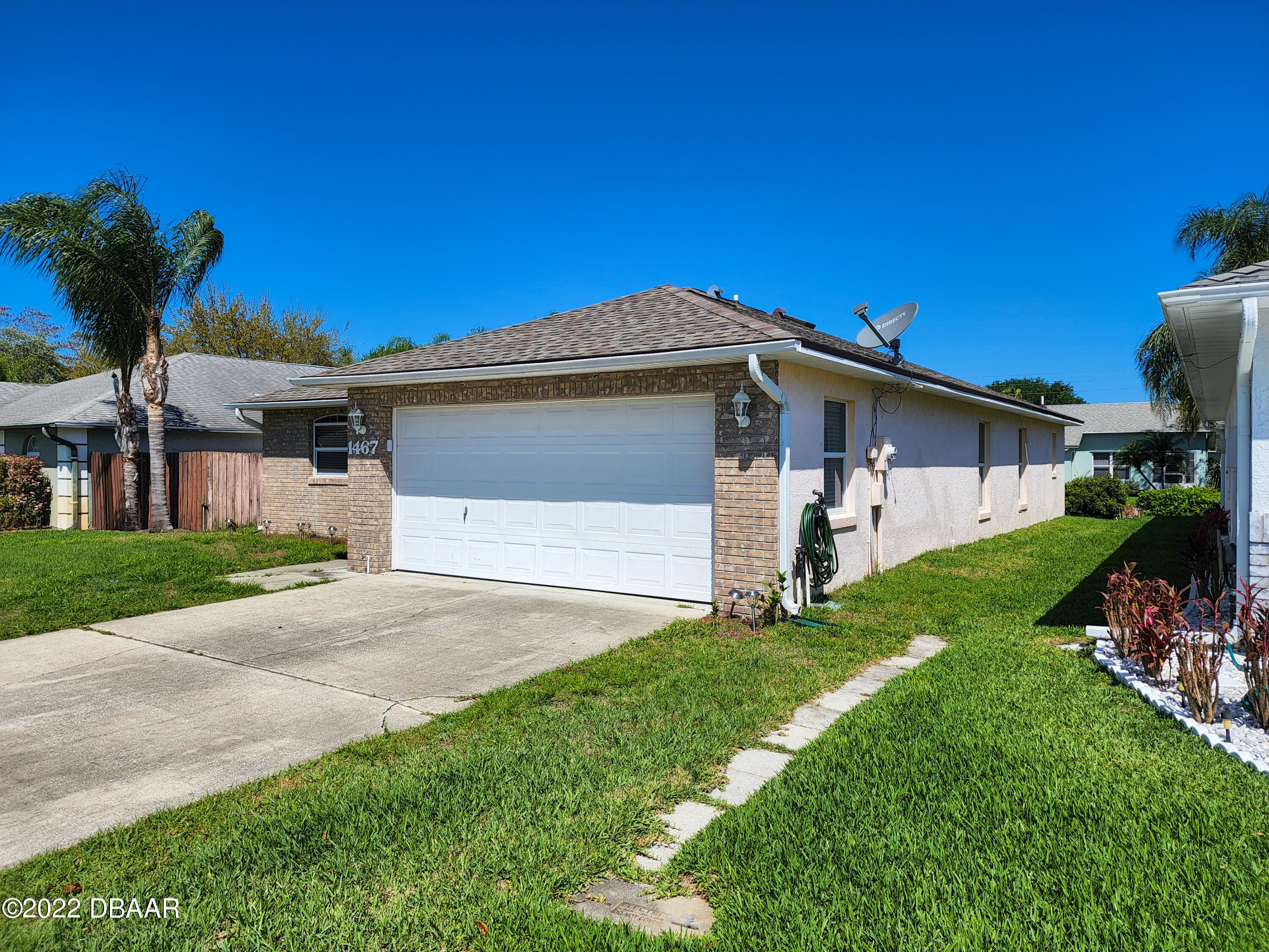 1467 Bay Grove Drive Port Orange, FL 32129 - Photo 4 of 35 a front view of a house with a yard and garage