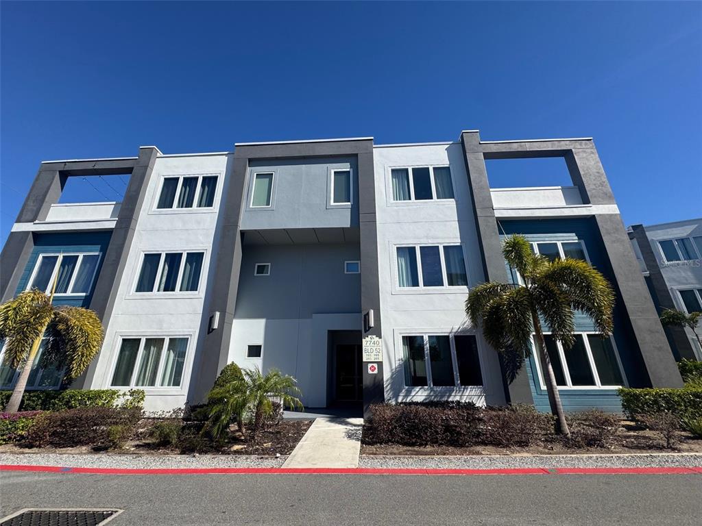 7740 Sandy Ridge Drive, Unit 205 Reunion, FL 34747 - Photo 1 of 1 a front view of residential houses with yard