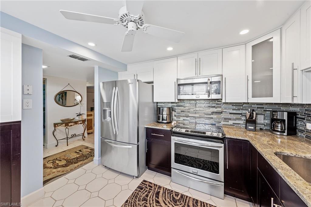 a kitchen with stainless steel appliances granite countertop a stove and a refrigerator