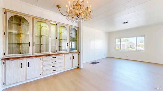 a view of a bedroom with wooden floor and a window