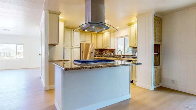 a kitchen with stainless steel appliances white cabinets and a sink