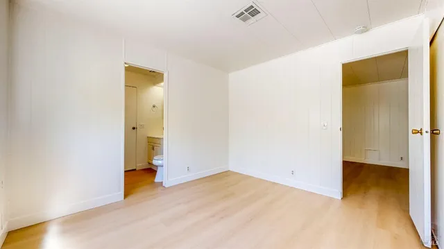 a view of an empty room with glass door