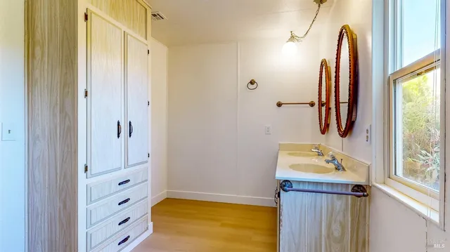 a view of swimming pool with lawn chairs and plants