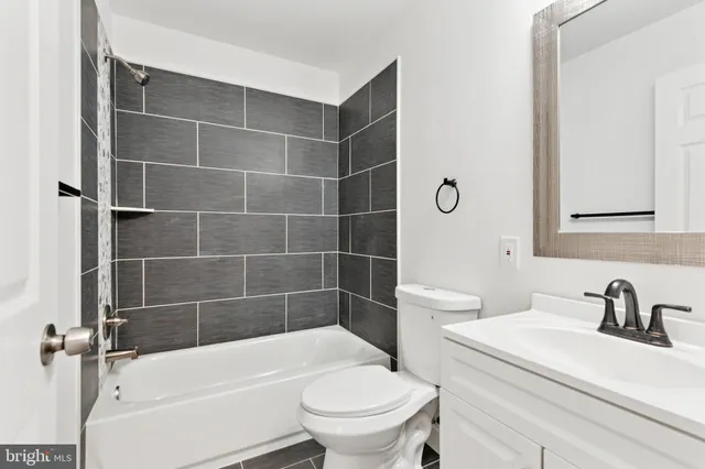 a bathroom with a sink a toilet and a bathtub