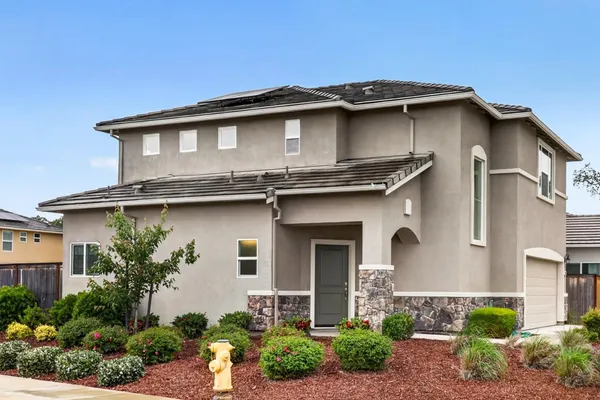 a front view of a house with garden