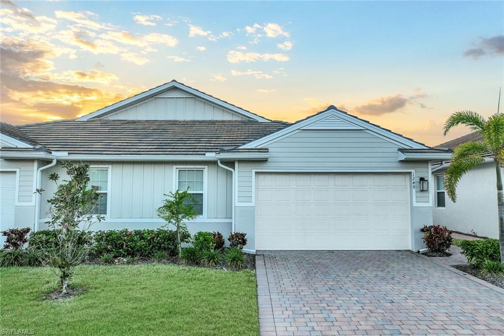 1249 Enbrook Loop Naples, FL 34114 - Photo 1 of 27 Single story home featuring a garage and a lawn