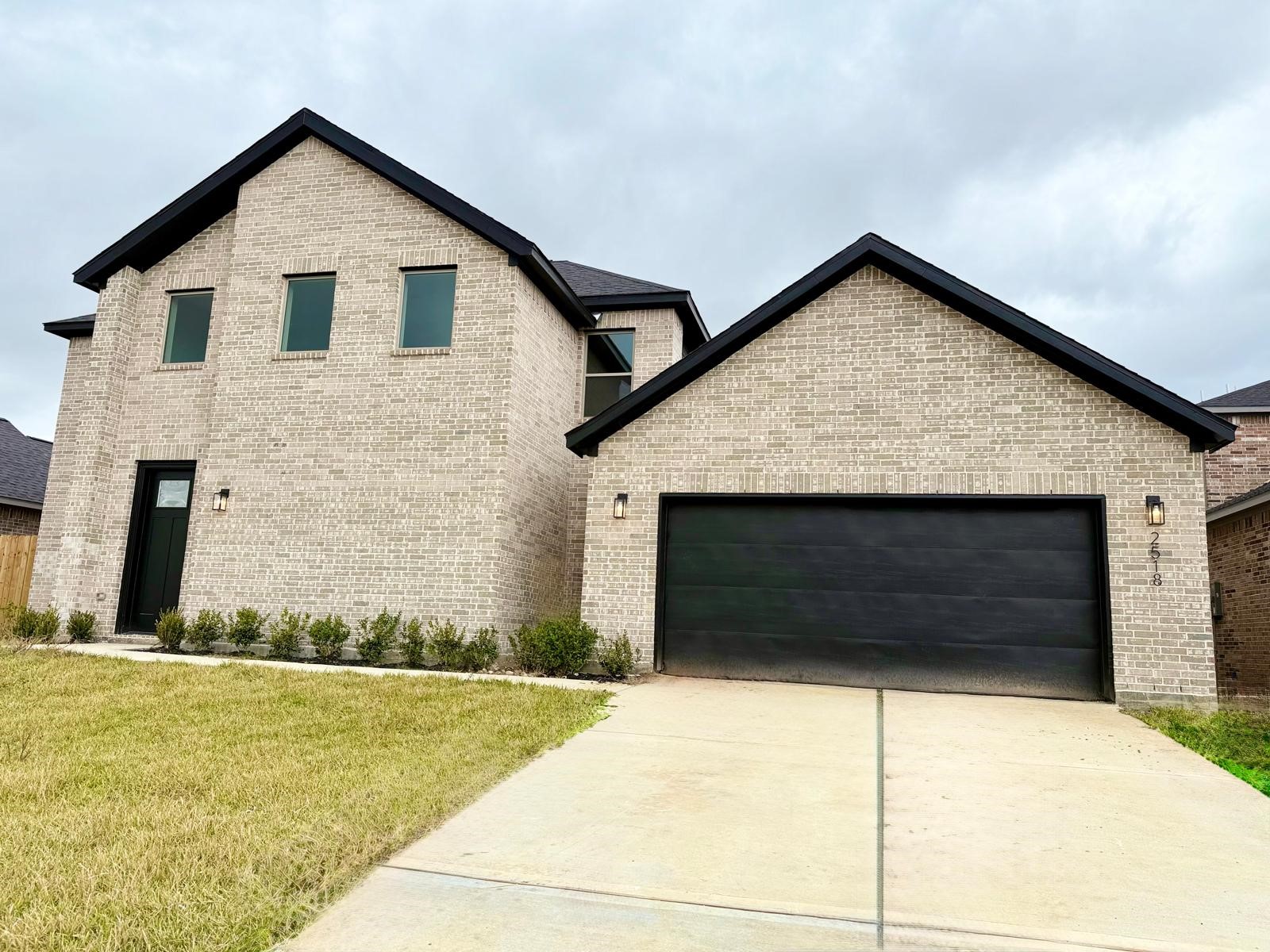 Discover your new home at 2518 Liguria. This stunning brick residence offers modern elegance and ample space, featuring a sleek facade and inviting entryway. Perfect for those seeking style and comfort.
