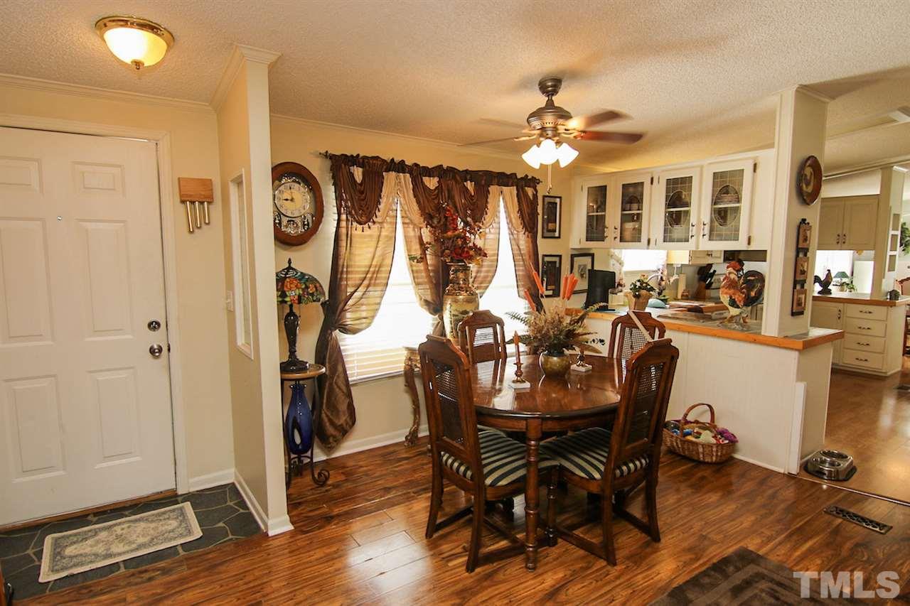5699 Elevation Road Benson, NC 27504 - Photo 3 of 24 a view of a dining room with furniture and wooden floor