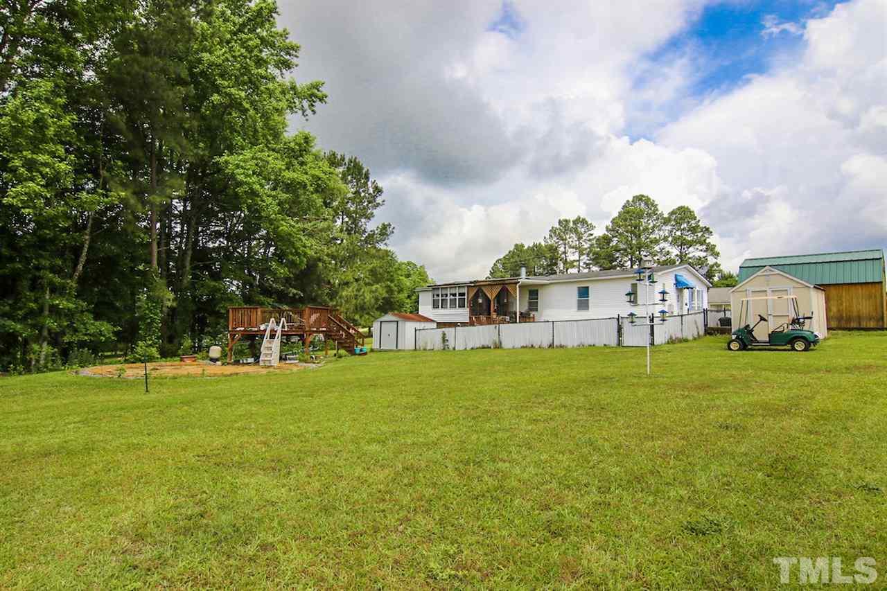 5699 Elevation Road Benson, NC 27504 - Photo 22 of 24 a house view with a garden space