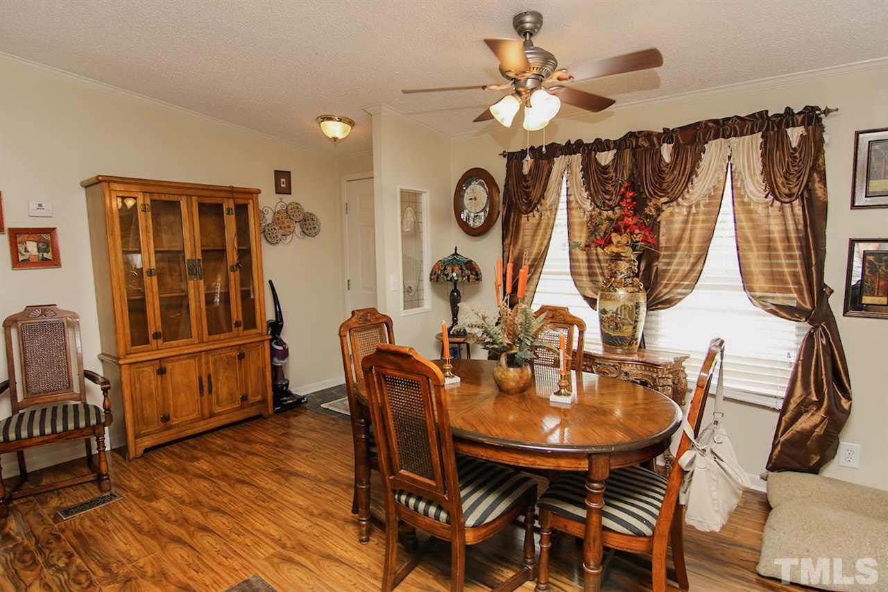 5699 Elevation Road Benson, NC 27504 - Photo 4 of 24 a view of a dining room with furniture and wooden floor