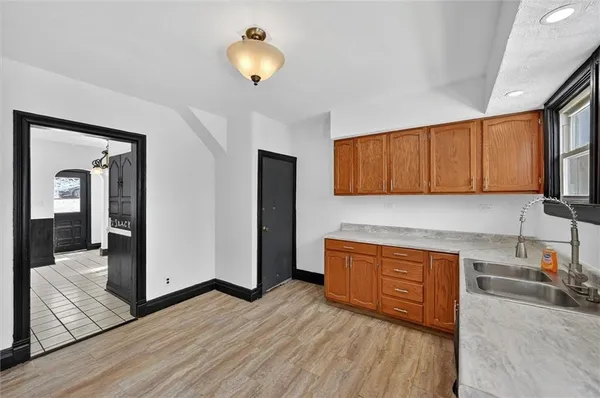 a kitchen with stainless steel appliances granite countertop a refrigerator a stove and a wooden floors