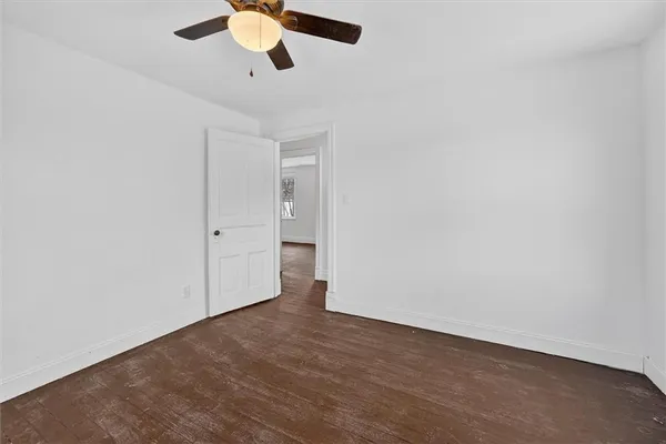 an empty room with a empty space and a ceiling fan