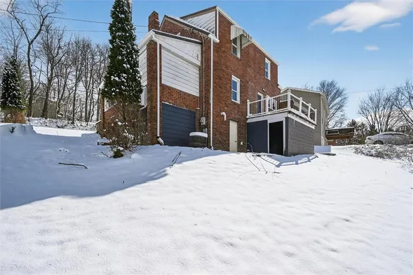 a view of a house with a snow in the yard