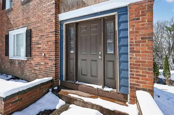 a brick building with a bench and shower