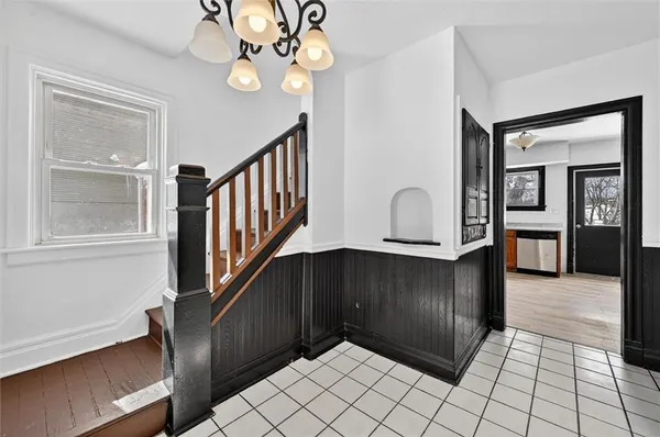 a view of an entryway with wooden floor and staircase