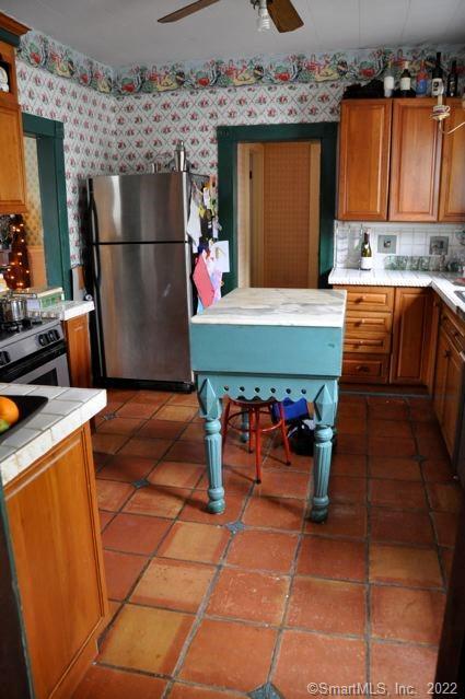 1 Cottage Street Norwalk, CT 06855 - Photo 4 of 7 a kitchen with stainless steel appliances kitchen island granite countertop a refrigerator and a stove top oven