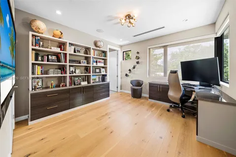 a view of a livingroom with workspace and a flat screen tv