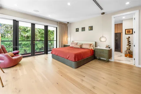 a large bedroom with a large bed and a large window