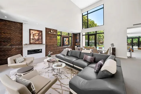 a living room with furniture fireplace and a large window
